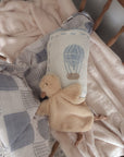 Baby comfort blanket with plush toy on a crib