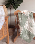 Woven tennis basket with a green and white pattern on a vintage cradle