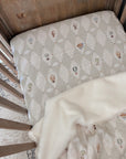 Vintage cot with a Up and Away fitted cot sheet and quilt
