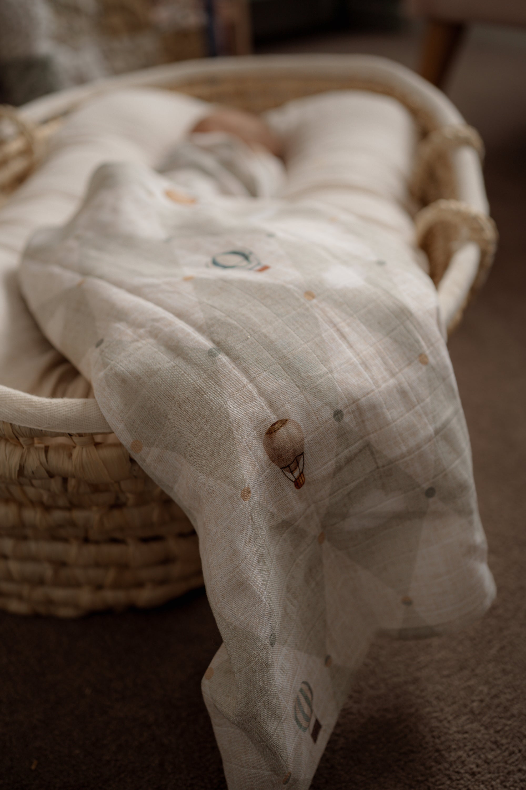 White textured blanket draped over a wicker basket on a carpeted floor
