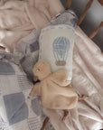 Baby comfort blanket with plush toy on a crib