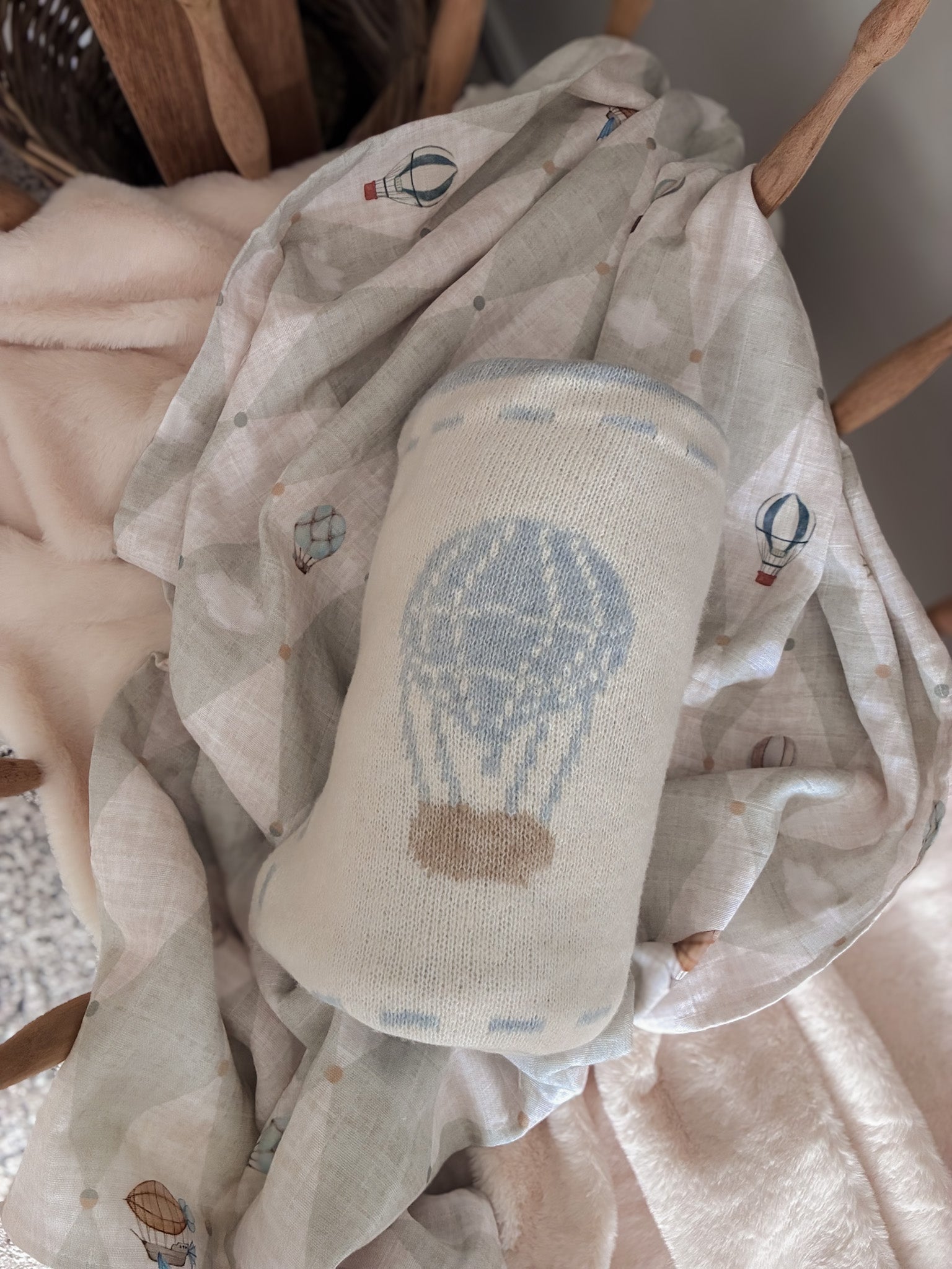 Baby blanket with hot air balloon design on a textured fabric background