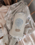 Baby blanket with hot air balloon design on a textured fabric background