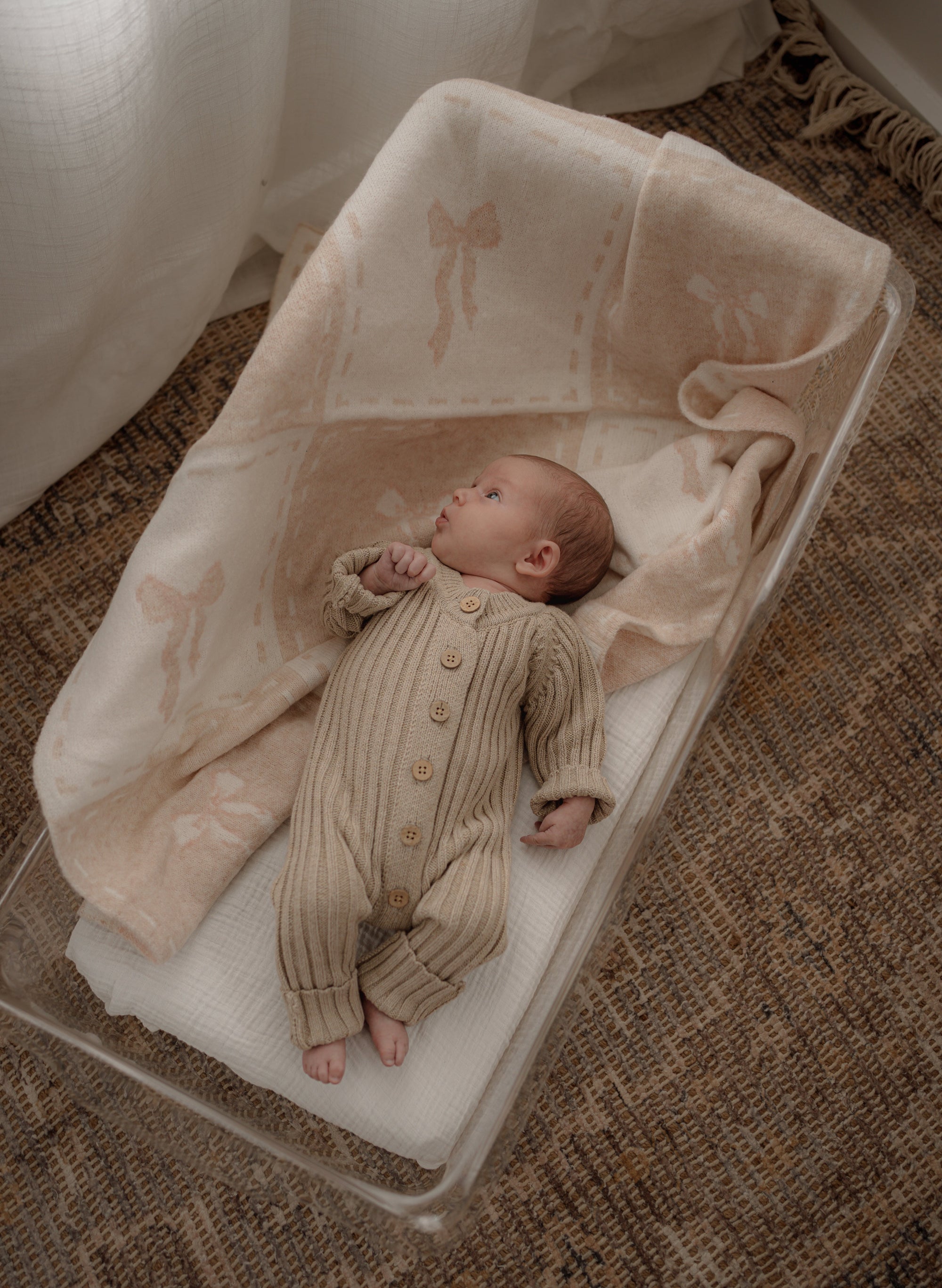 Newborn baby lying on a soft pop ya tot  blanket.
