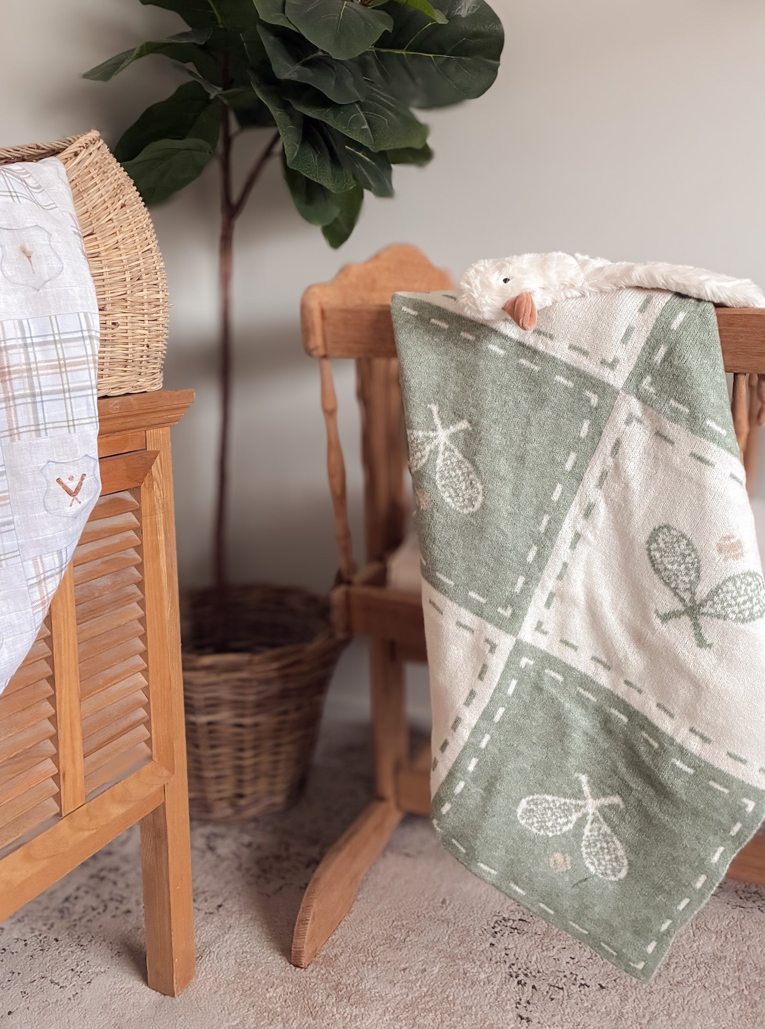 Woven tennis basket with a green and white pattern on a vintage cradle